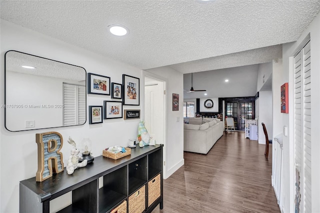 hall with recessed lighting, baseboards, a textured ceiling, and wood finished floors