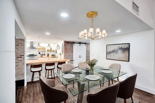 dining space featuring dark wood finished floors, a barn door, recessed lighting, and visible vents