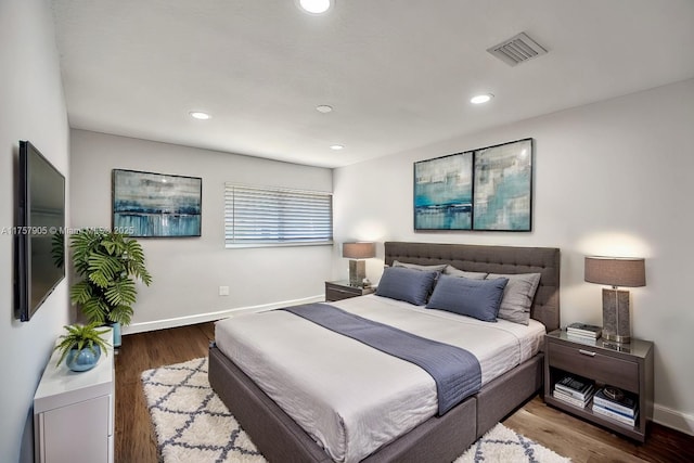 bedroom with visible vents, recessed lighting, baseboards, and wood finished floors