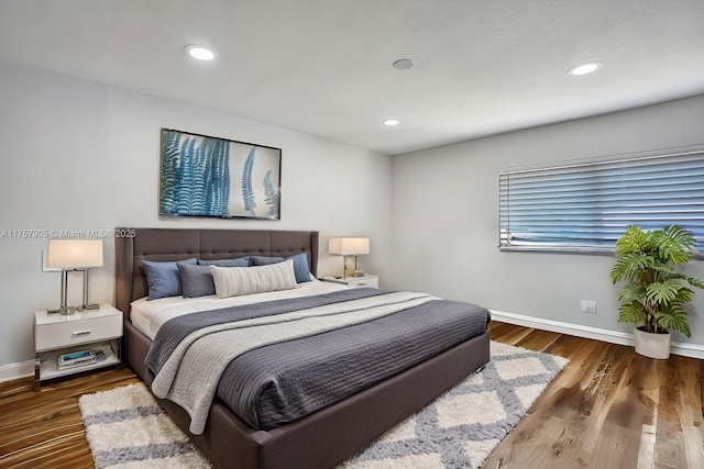 bedroom with recessed lighting, baseboards, and wood finished floors