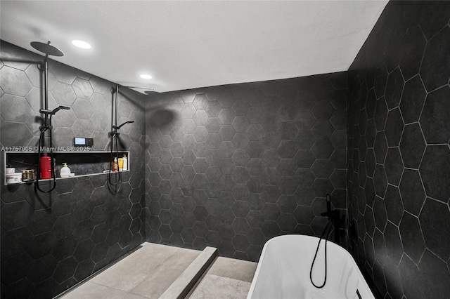 bathroom featuring a tile shower and a soaking tub