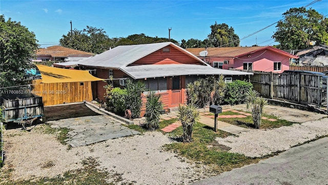 rear view of property featuring fence