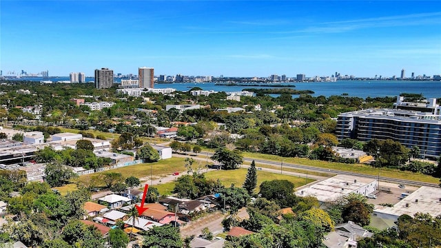 birds eye view of property with a view of city and a water view