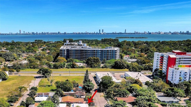 birds eye view of property featuring a city view and a water view