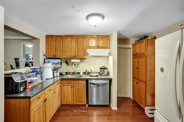 kitchen with a sink, dark countertops, freestanding refrigerator, dishwasher, and dark wood-style flooring