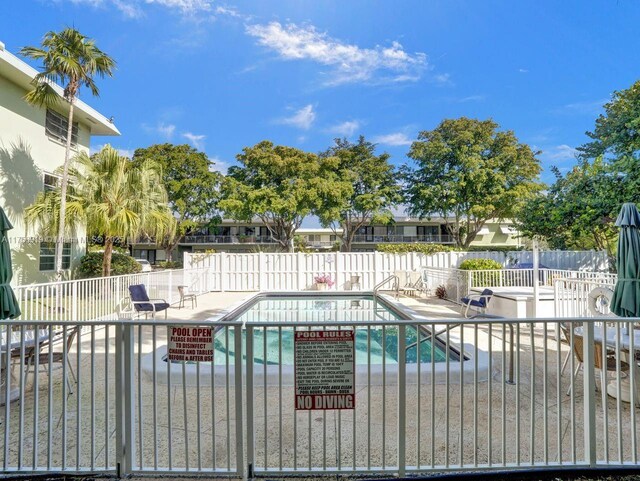 1900 NE 8th Ct Unit 306, Fort Lauderdale, FL 33304 - community pool with a patio area and fence