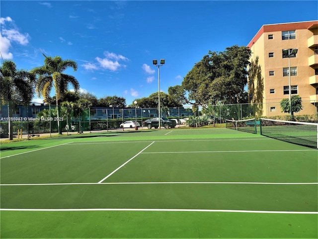 view of sport court featuring fence