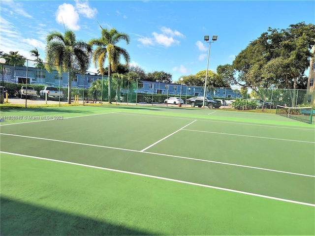 view of tennis court with fence