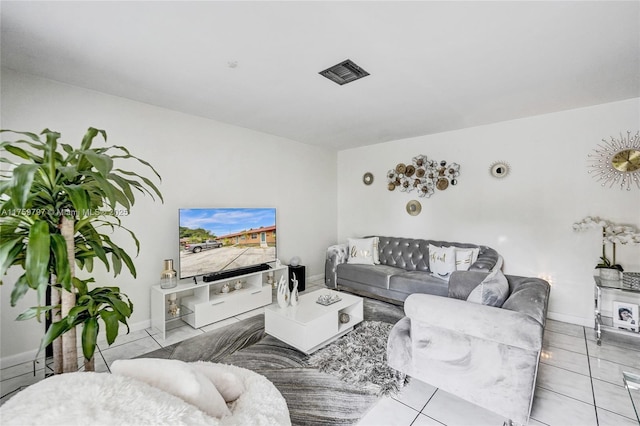 tiled living area with baseboards and visible vents