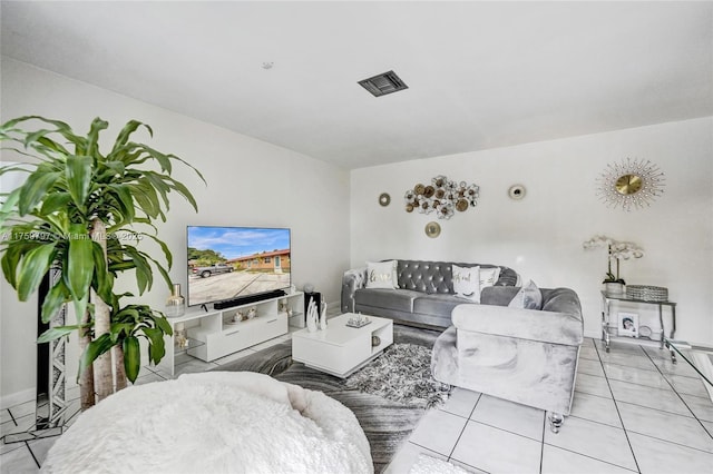 living area with visible vents and light tile patterned flooring