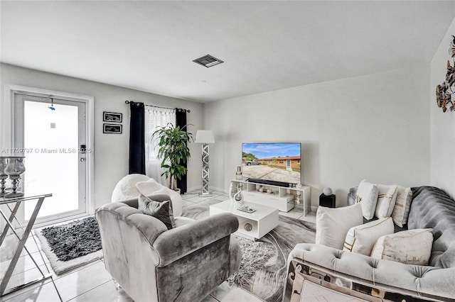 living area featuring visible vents and plenty of natural light