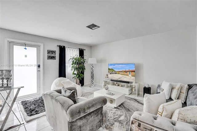 living area with visible vents and marble finish floor