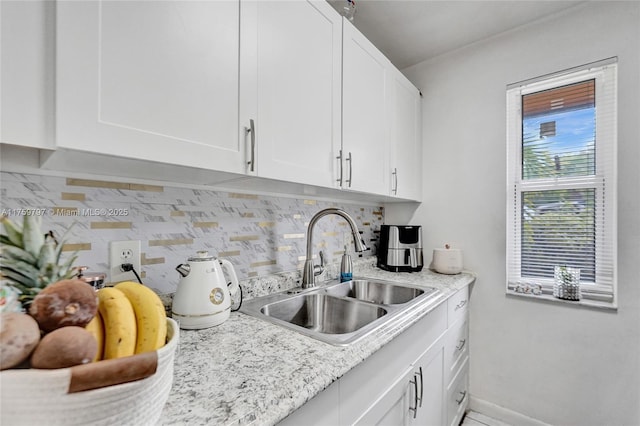 6069 SW 35th St, Miramar, FL 33023 - kitchen with a sink, white cabinetry, decorative backsplash, and baseboards