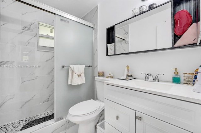 bathroom featuring vanity, toilet, marble finish floor, and a marble finish shower