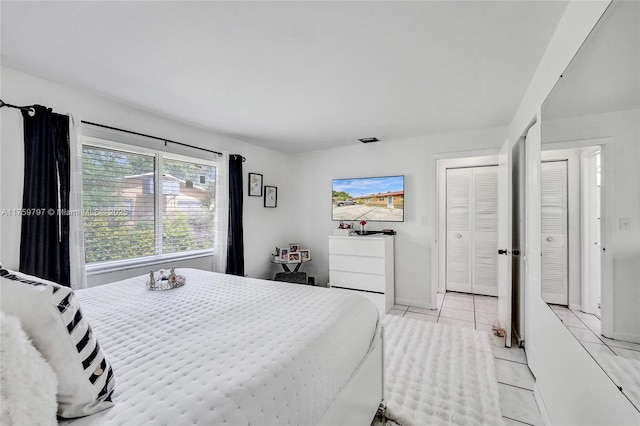 bedroom with light tile patterned floors and visible vents