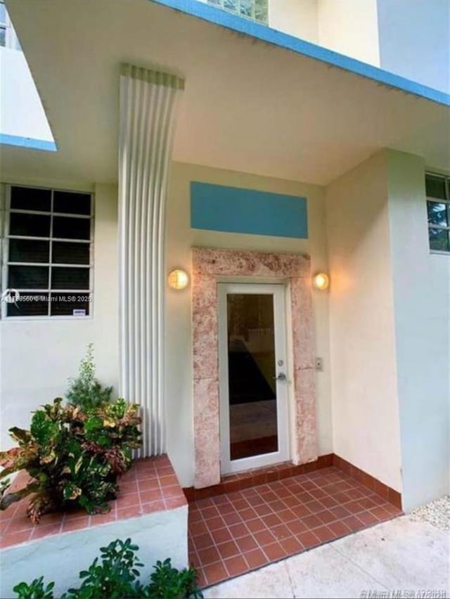 property entrance with stucco siding