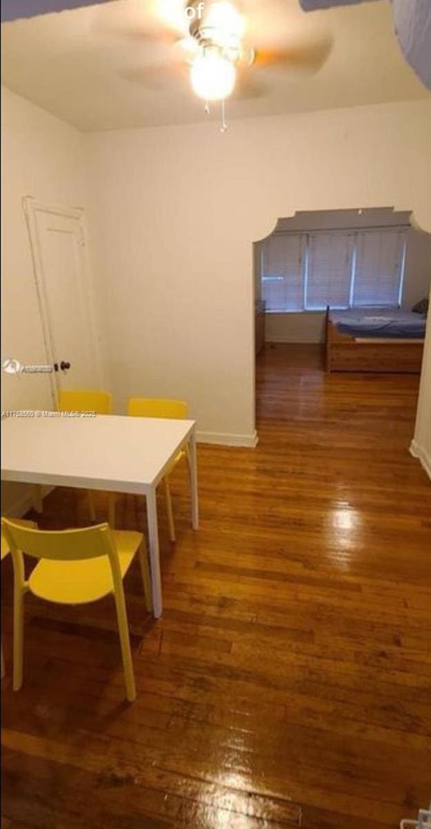 dining area with wood finished floors, baseboards, and ceiling fan