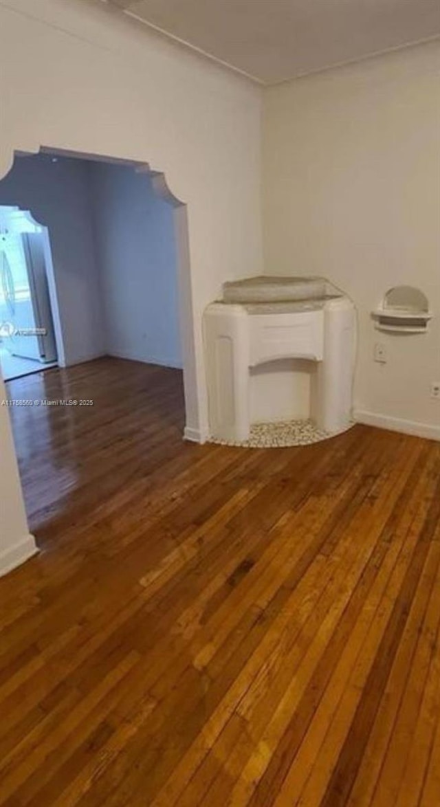 empty room with hardwood / wood-style floors