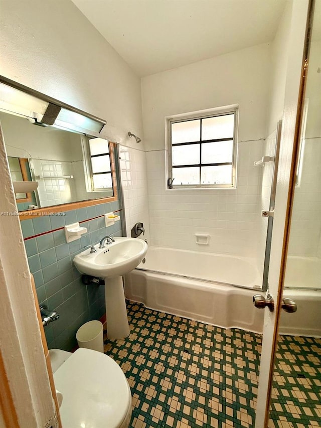 830 Euclid Ave Unit 8, Miami Beach, FL 33139 - bathroom with tile walls, tub / shower combination, toilet, tile patterned floors, and a sink
