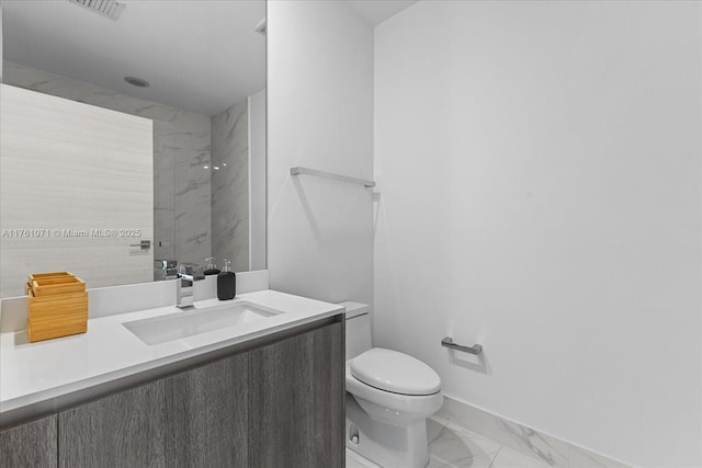 bathroom featuring vanity, visible vents, baseboards, toilet, and marble finish floor