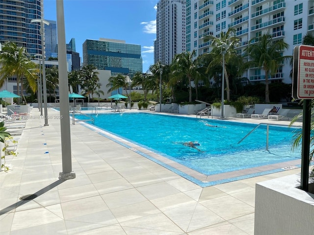 community pool featuring a city view and a patio