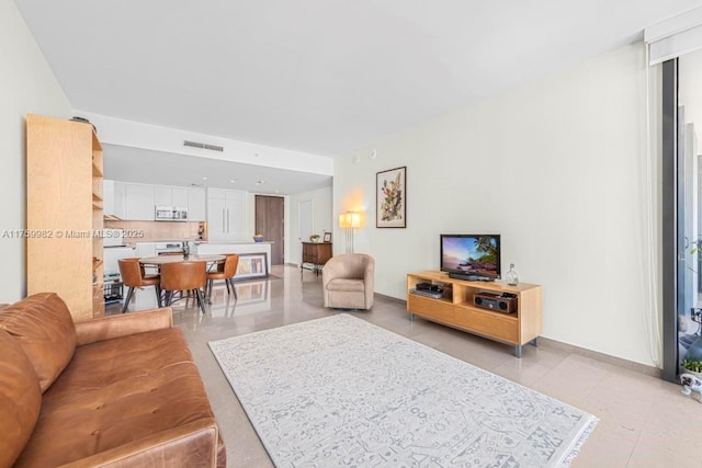 living room featuring visible vents and baseboards