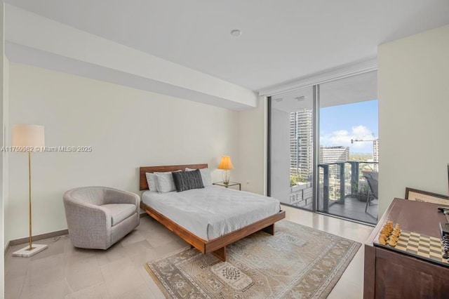 bedroom featuring a wall of windows, access to outside, and baseboards