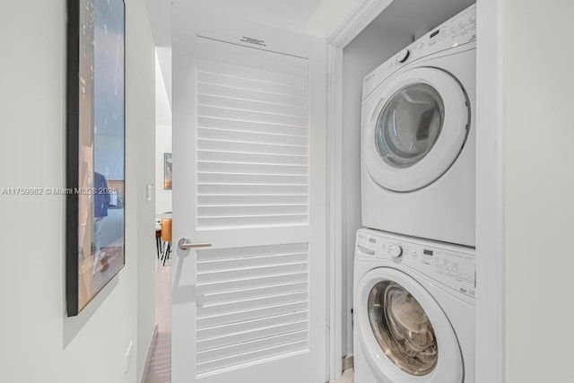 laundry area featuring stacked washer and clothes dryer and laundry area