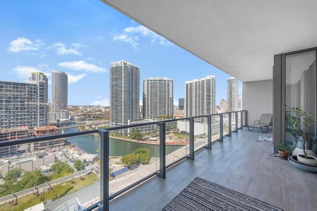 balcony featuring a view of city and a water view