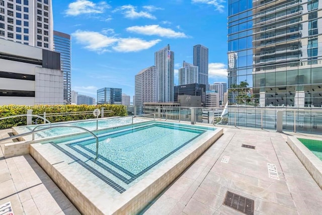 view of swimming pool featuring a view of city