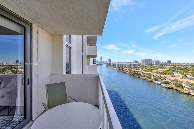 balcony featuring a city view and a water view