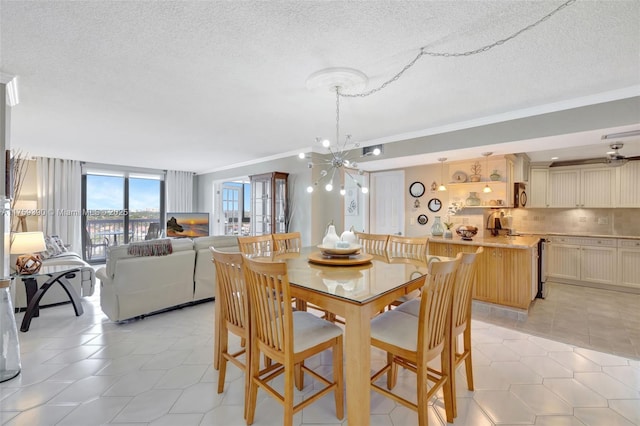 dining space featuring an inviting chandelier, ornamental molding, light tile patterned flooring, and a textured ceiling