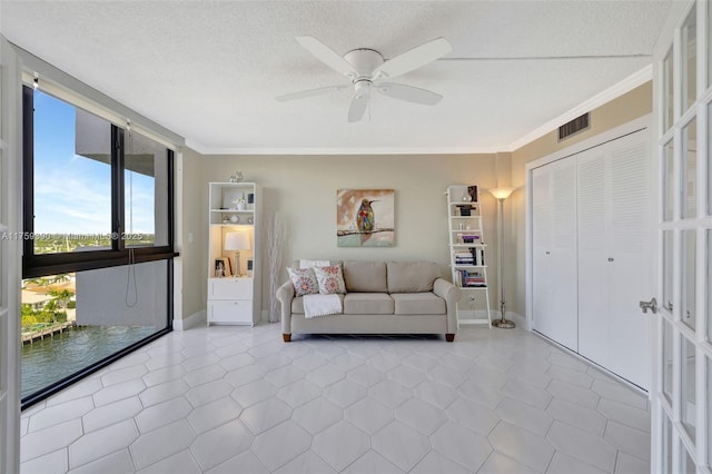 unfurnished living room with visible vents, a textured ceiling, and crown molding