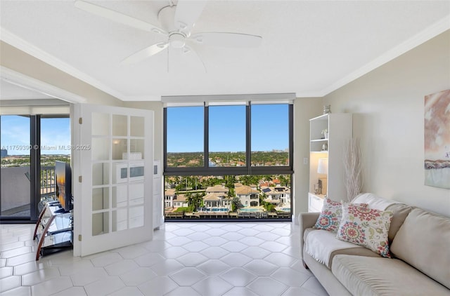 living area featuring floor to ceiling windows, a ceiling fan, and ornamental molding