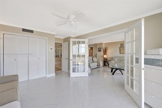 interior space featuring visible vents, crown molding, baseboards, ceiling fan, and french doors