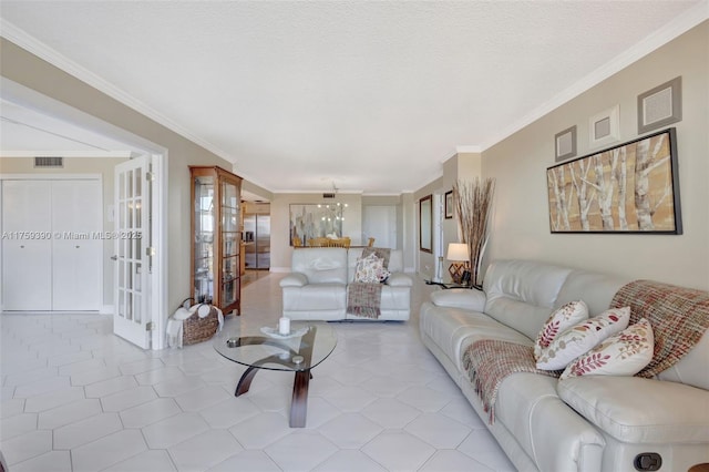 living room with light tile patterned flooring, visible vents, a textured ceiling, and ornamental molding