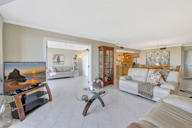 living area featuring light tile patterned floors, a notable chandelier, and crown molding