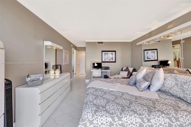 bedroom with tile patterned floors, crown molding, visible vents, and a textured ceiling