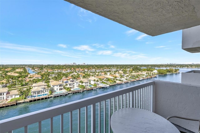 balcony with a residential view and a water view