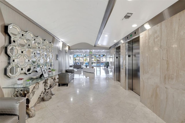 hall featuring vaulted ceiling, elevator, french doors, and visible vents