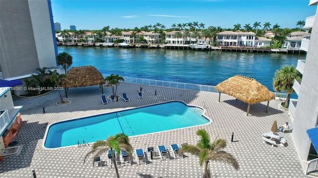 view of pool with a residential view and a water view