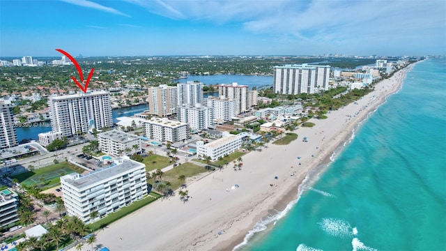 bird's eye view featuring a view of city, a water view, and a beach view