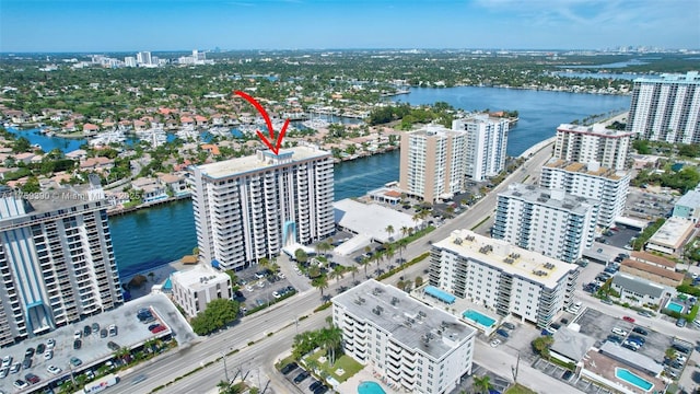 birds eye view of property with a view of city and a water view