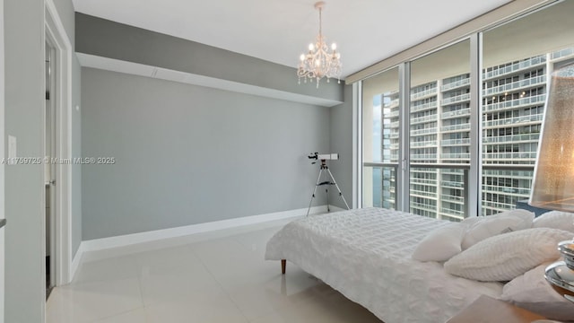 bedroom featuring tile patterned floors, a notable chandelier, baseboards, and expansive windows