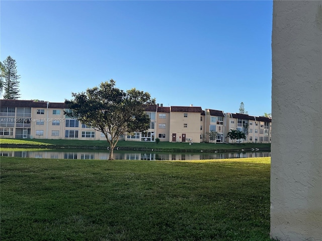 surrounding community featuring a yard and a water view