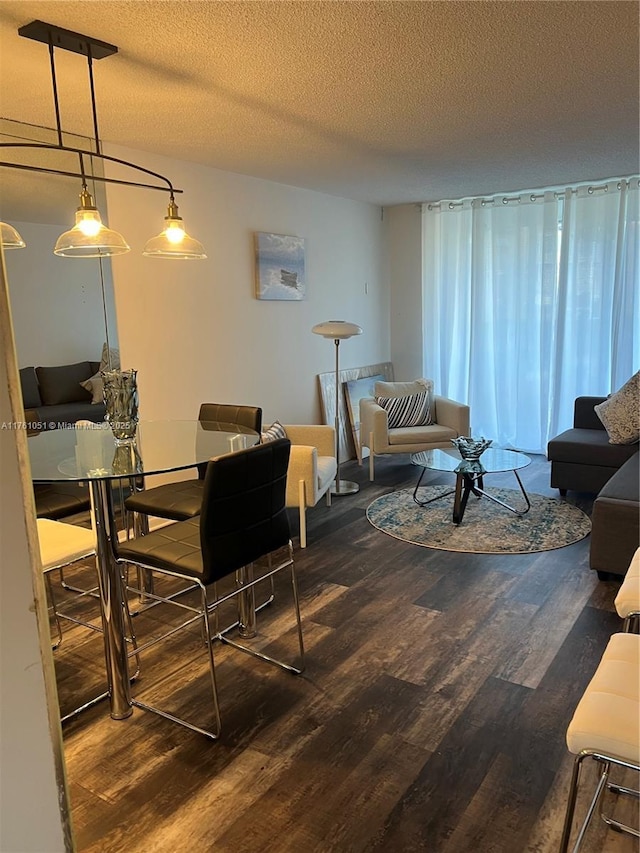 living room with a textured ceiling and wood finished floors