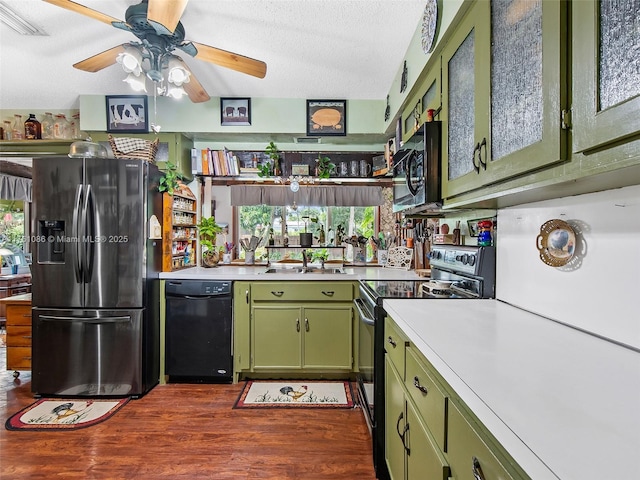 kitchen with visible vents, light countertops, plenty of natural light, black appliances, and green cabinetry