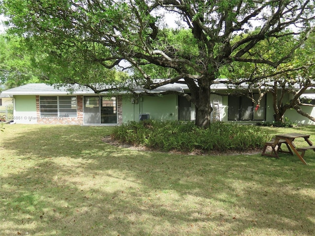 ranch-style house with brick siding and a front lawn