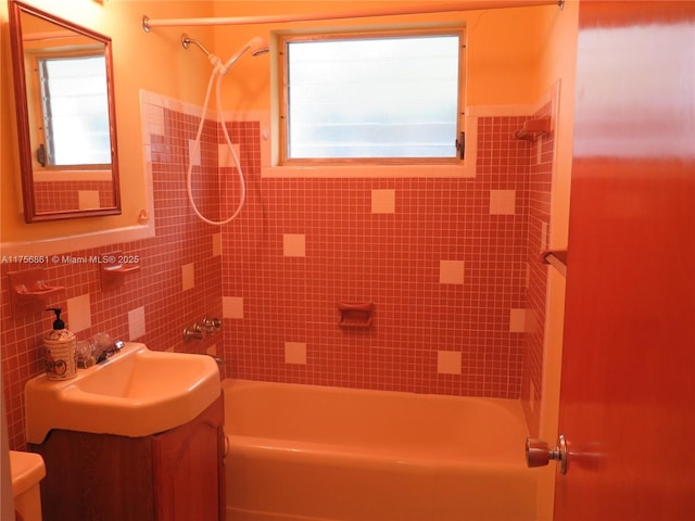 full bath featuring shower / bath combination, toilet, tile walls, and vanity