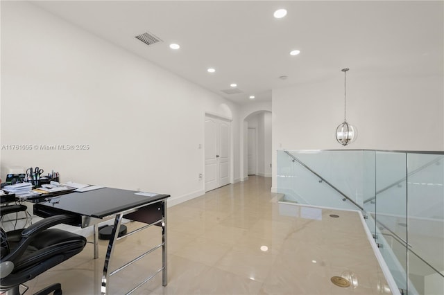 office area with recessed lighting, visible vents, arched walkways, and baseboards